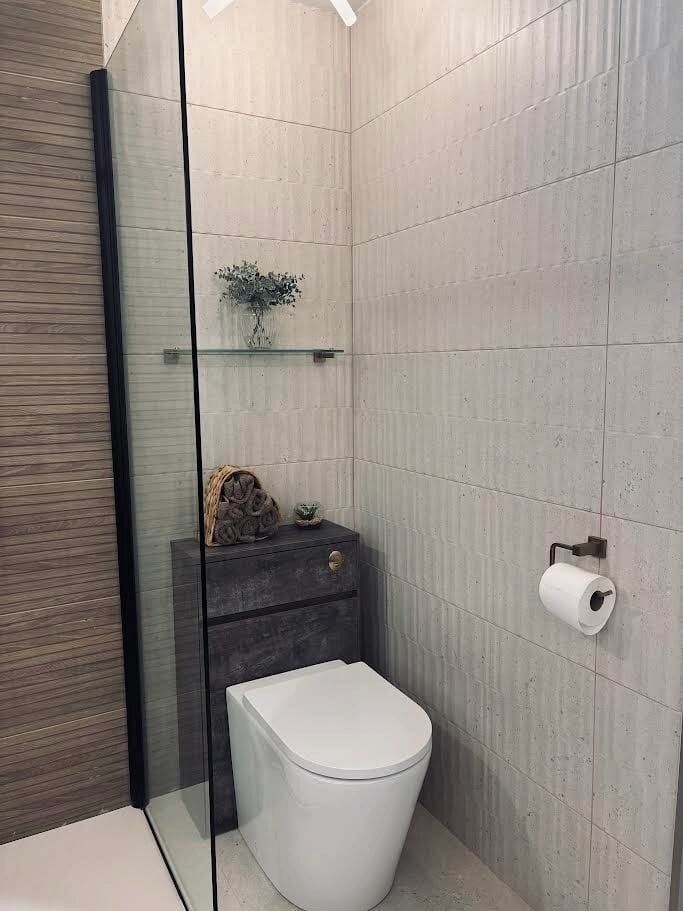 WC unit with wood effect and ribbed neutral organic stone effect tiles