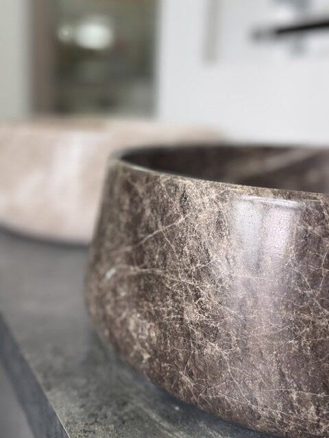 1. Close-up of an Emparador Dark Marzio honed marble countertop basin.