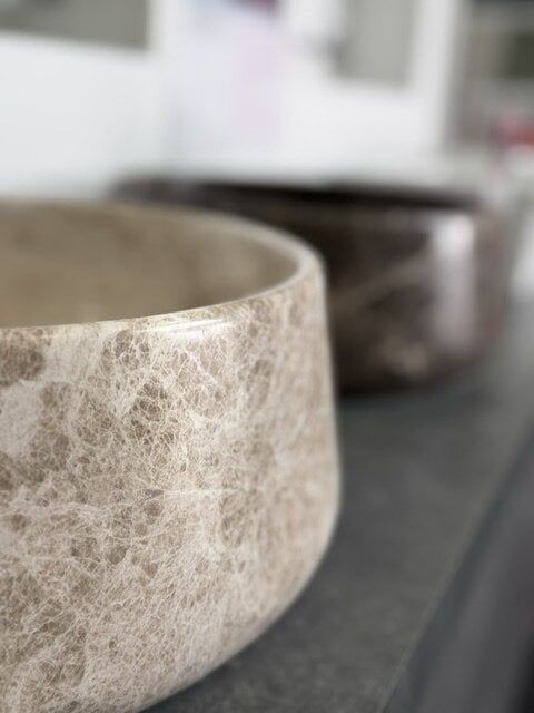Close-up of a Patara Beige Marzio honed marble countertop basin.
