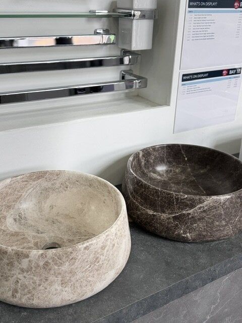 Patara Beige and Emparador Dark Marzio marble countertop basins displayed at Easy Bathrooms Chelmsford.