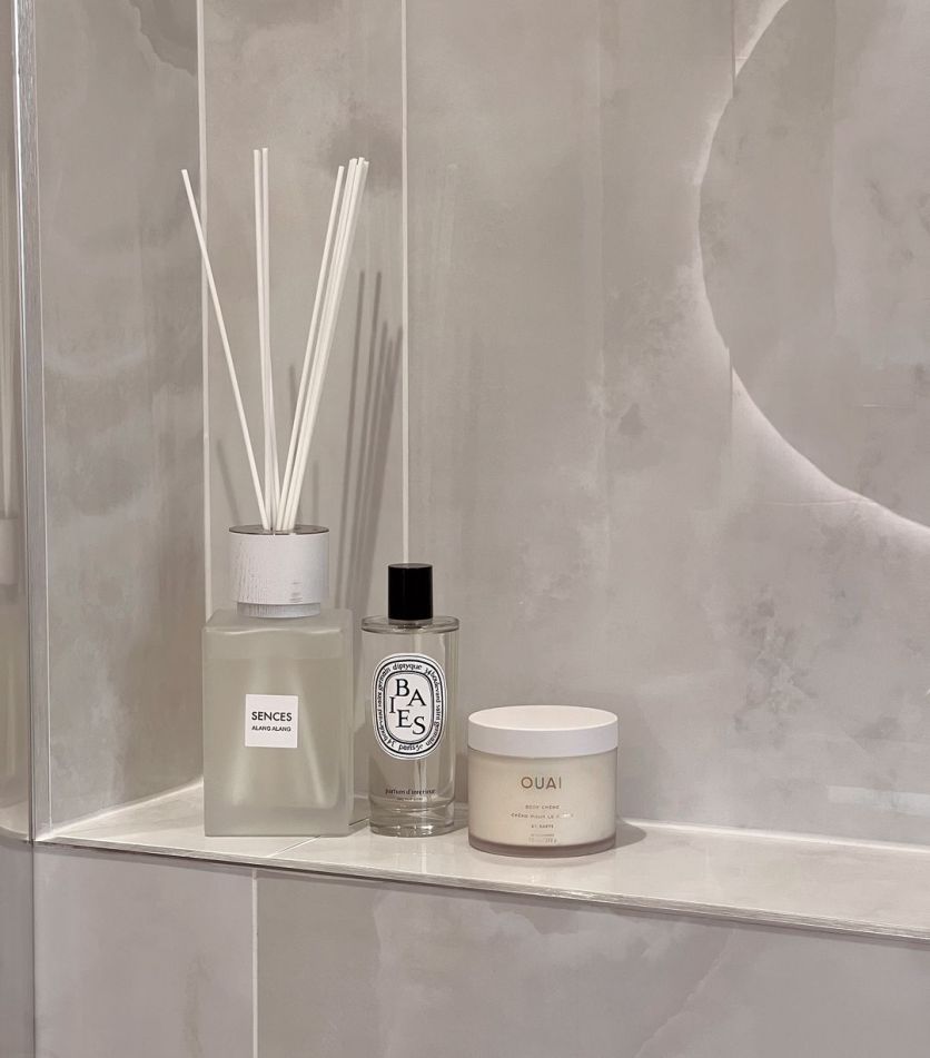 Osaka white super polished porcelain onyx tiles serve as a background for minimalist bathroom styling.