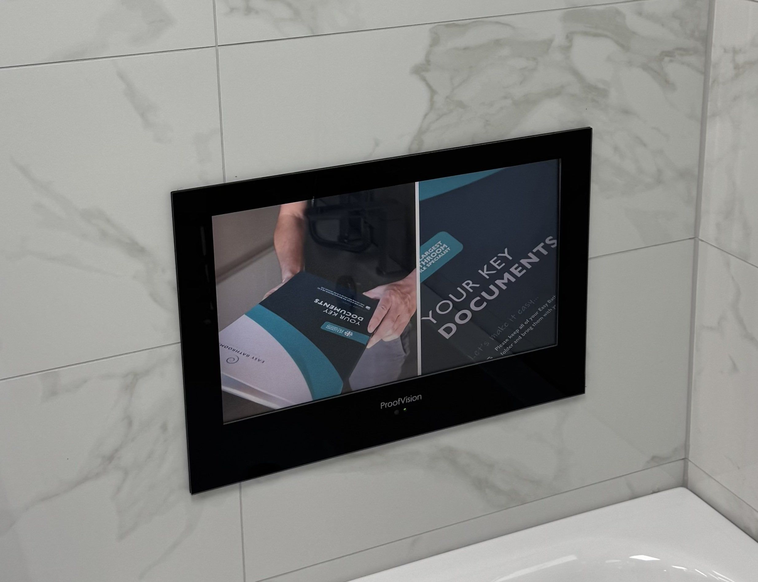 19-inch waterproof Smart TV installed within a tiled bathroom display at the Easy Bathrooms Rayleigh showroom.