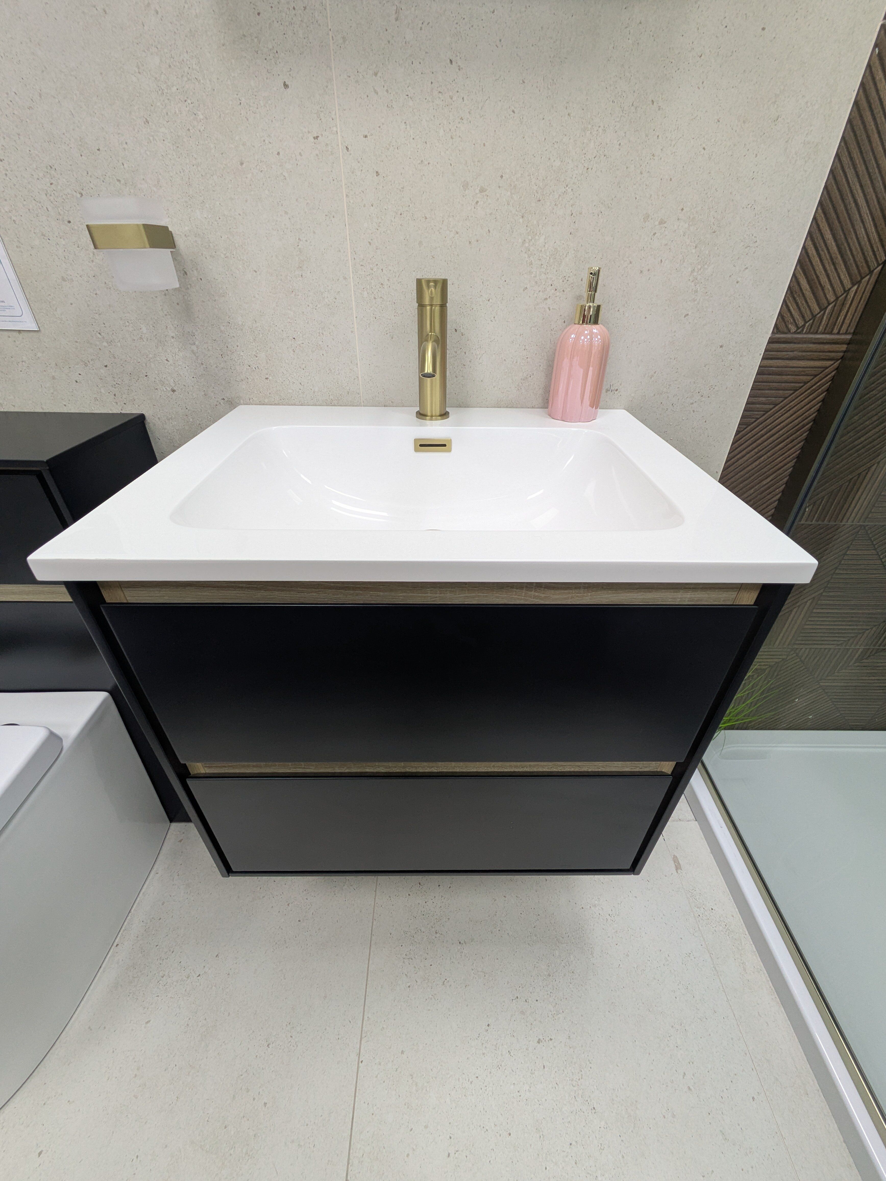 Modern bathroom display at Easy Bathrooms Lincoln with black furniture, wall-hung toilet and contrasting wood-effect tiles.