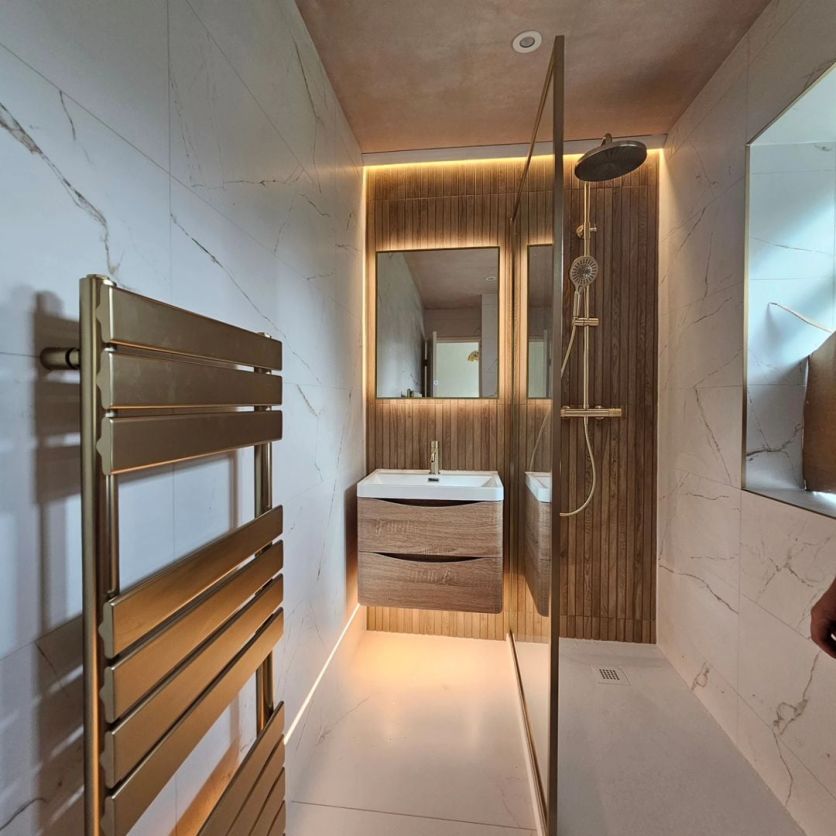 Erin light oak vanity and Rione gold mirror paired with champagne gold Moray brassware and Dune 4D tiles.