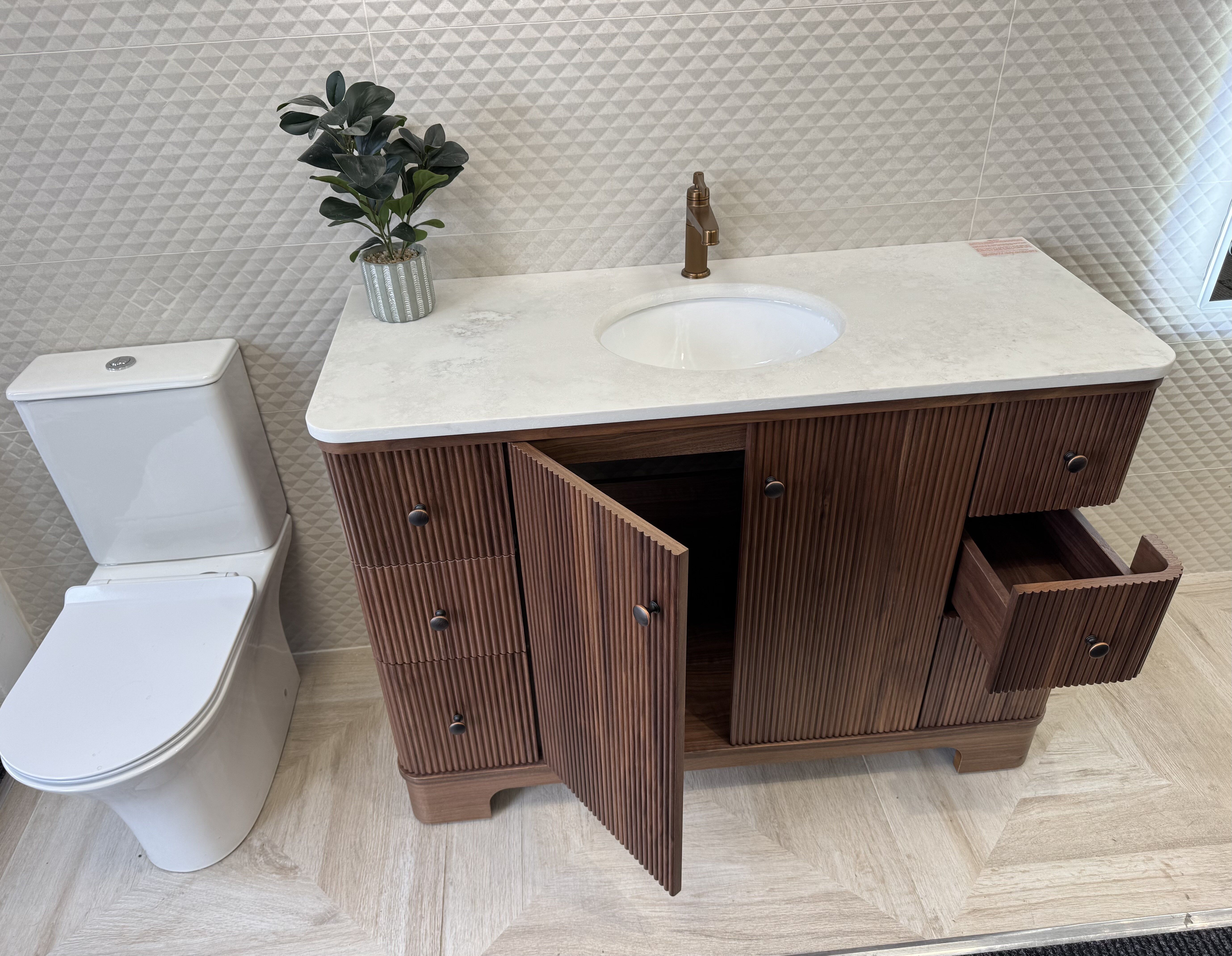 Hayward Walnut 1200mm vanity unit at Easy Bathrooms Rayleigh with doors open to show the internal storage.