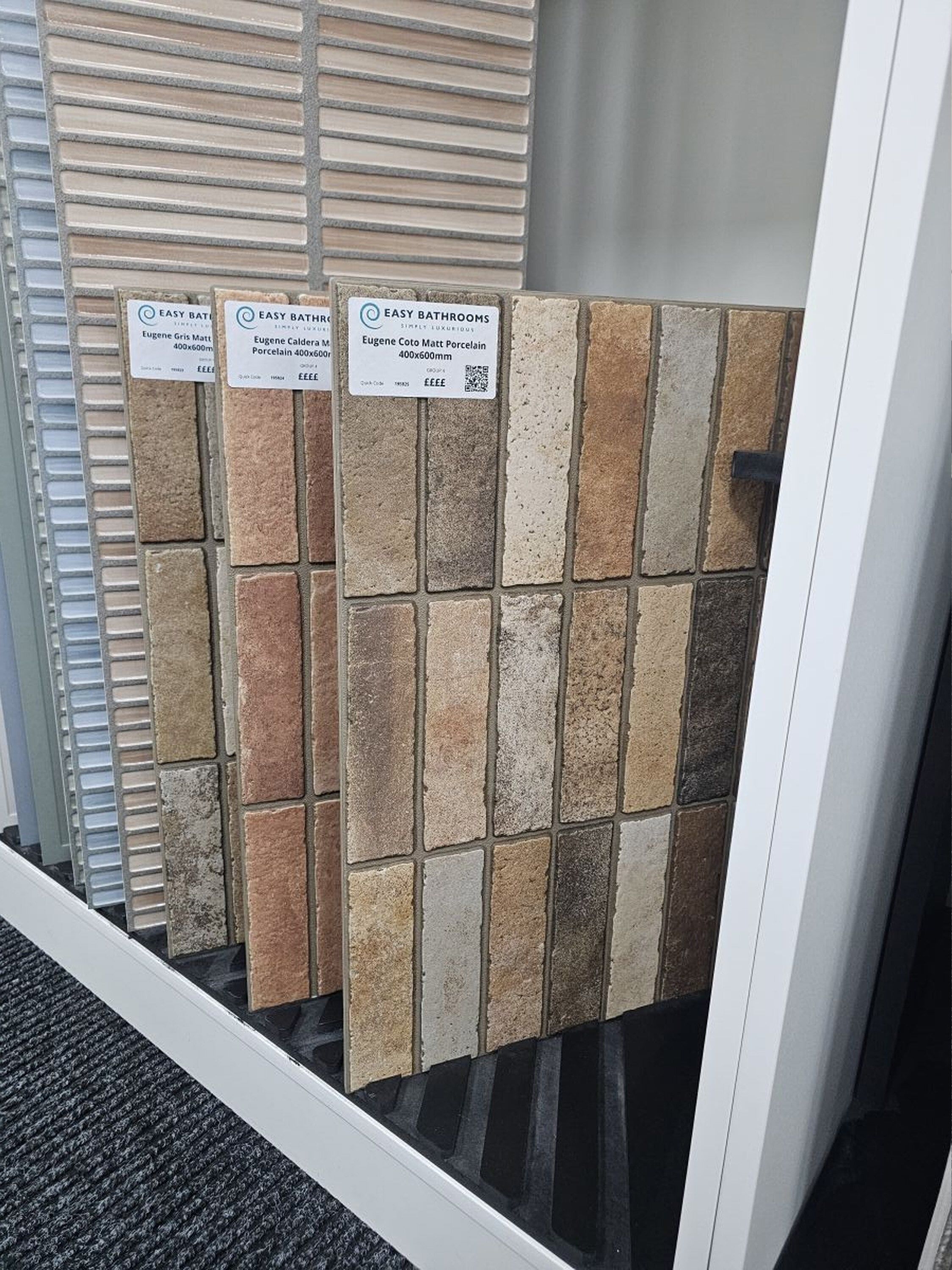 Brick-effect wall tile samples in warm beige, brown and terracotta tones.