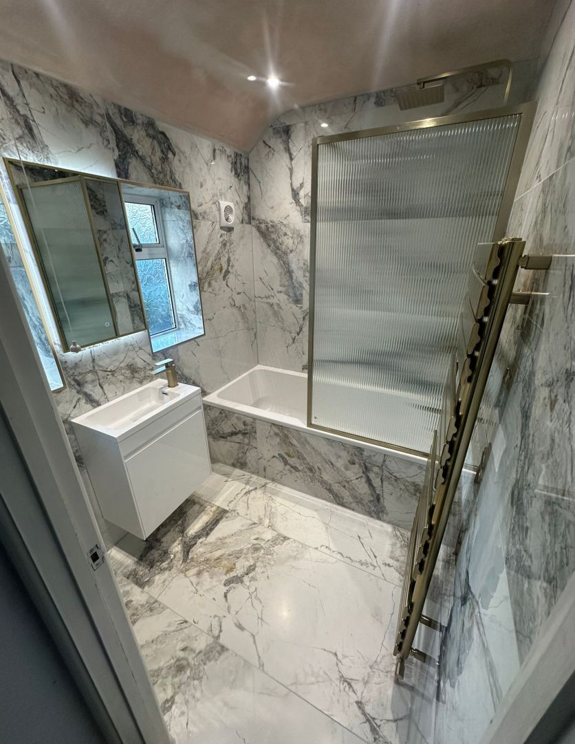 Brushed Gold Framed Fluted Glass Bath Screen