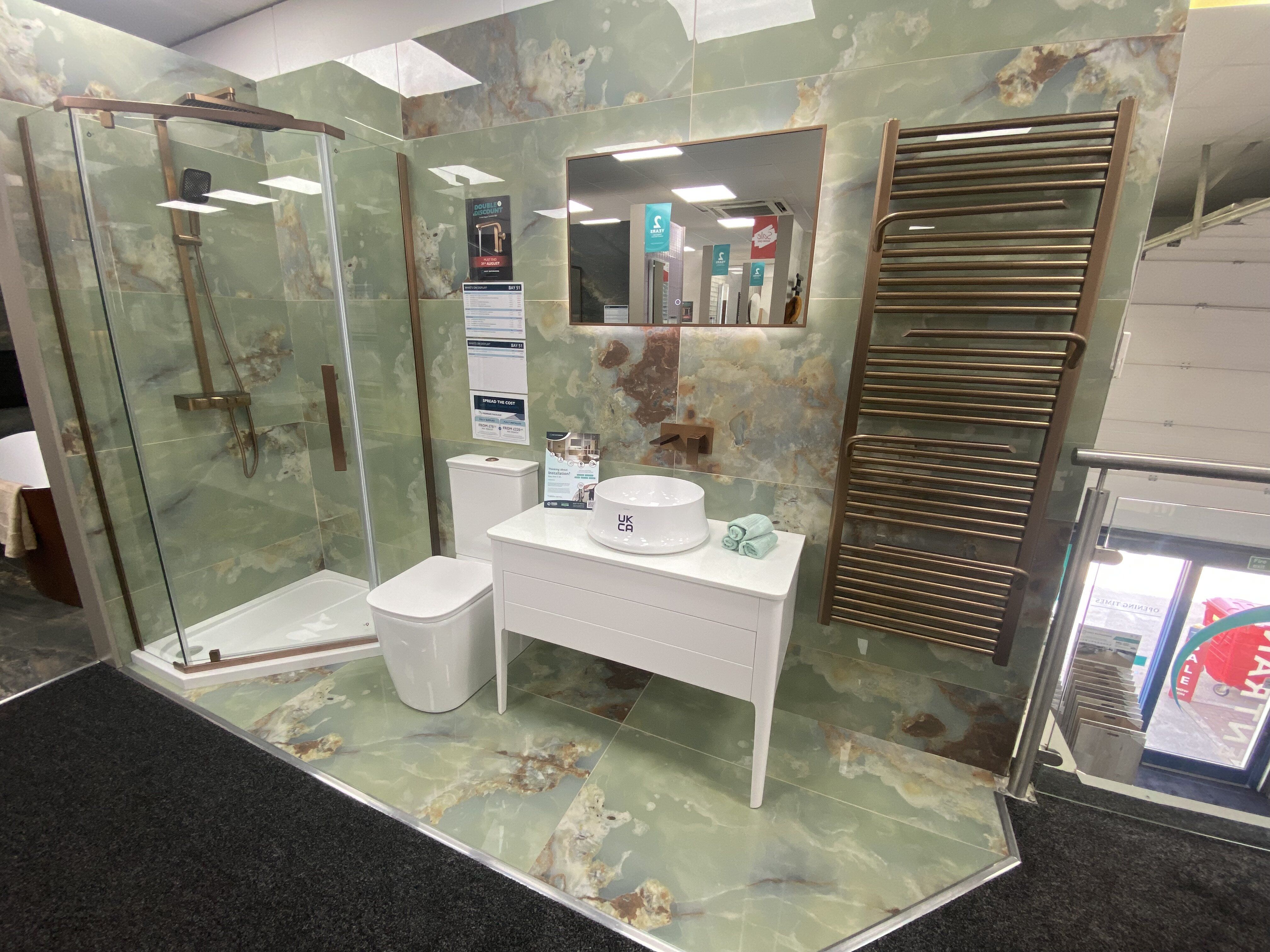 Wide view of the refurbished Easy Bathrooms Newbury showroom with new bathroom displays and tile areas.