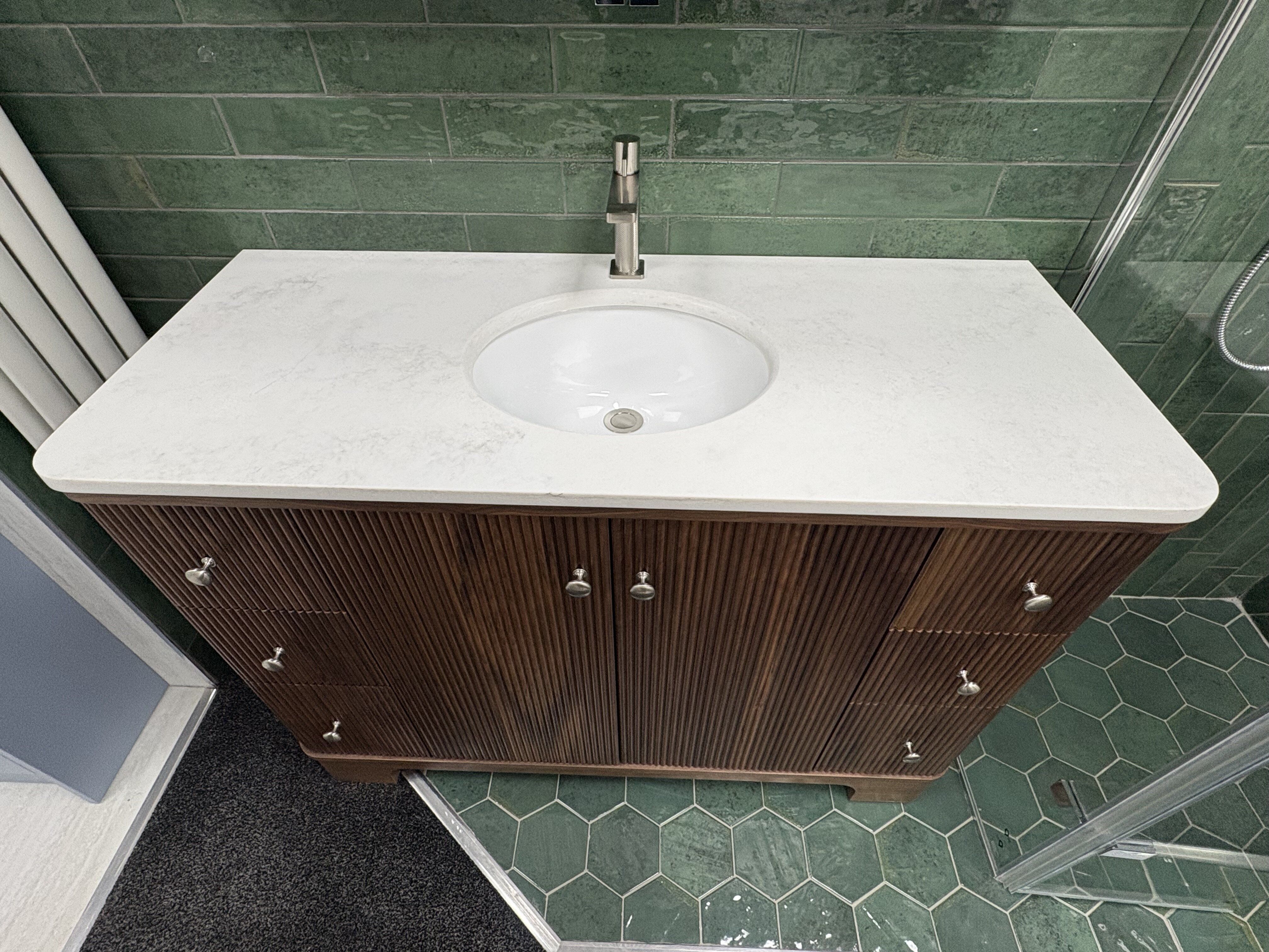 1. Overhead view of the natural quartz worktop, undermount basin and brushed nickel tap.