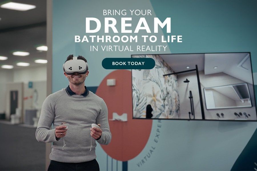 Customer using a virtual reality headset to explore a 3D bathroom design, with a bathroom visualisation displayed on a screen behind him.