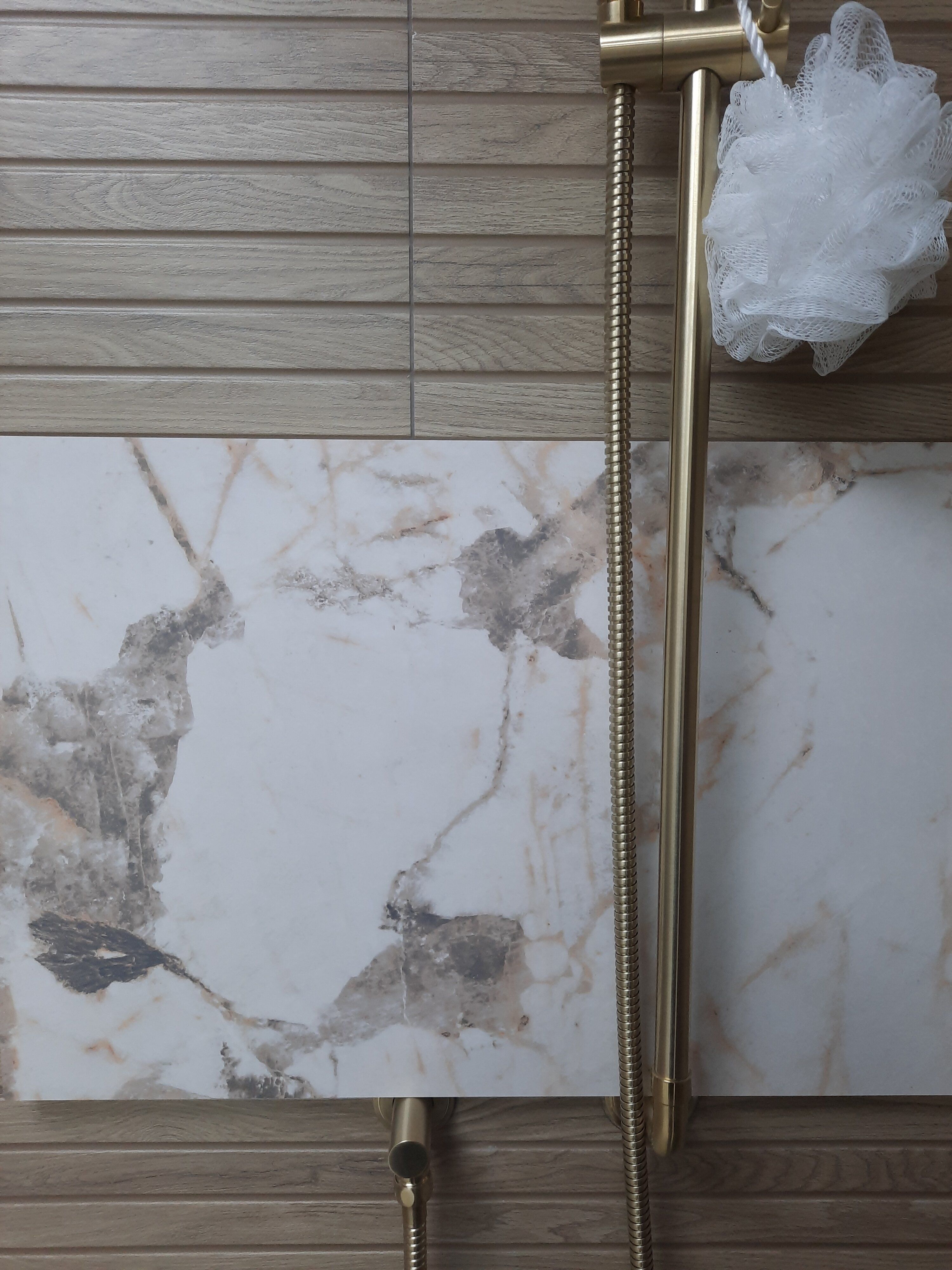 Light marble-effect Pristina PVC wall panel used in a bathroom setting at Easy Bathrooms Derby.