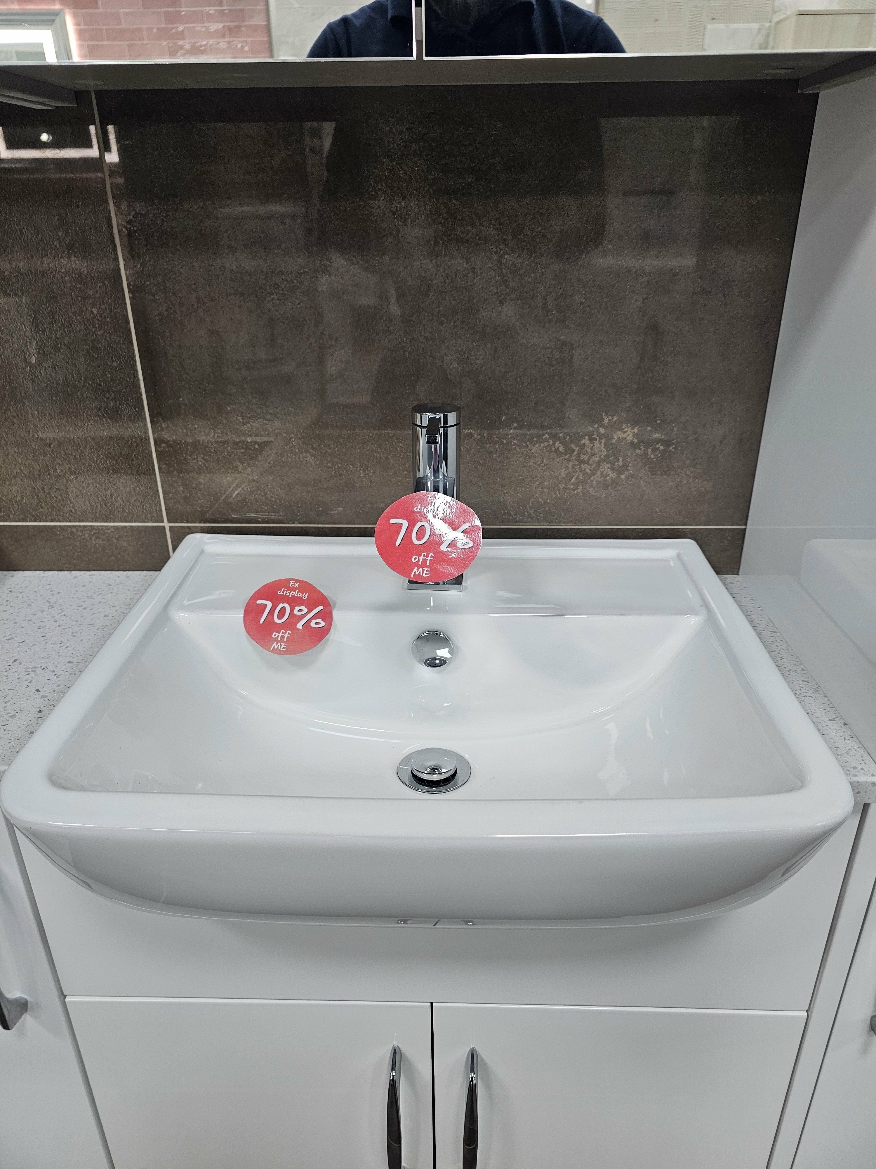 White ex-display bathroom basin with chrome tap and reduced-price labels at the Folkestone showroom.