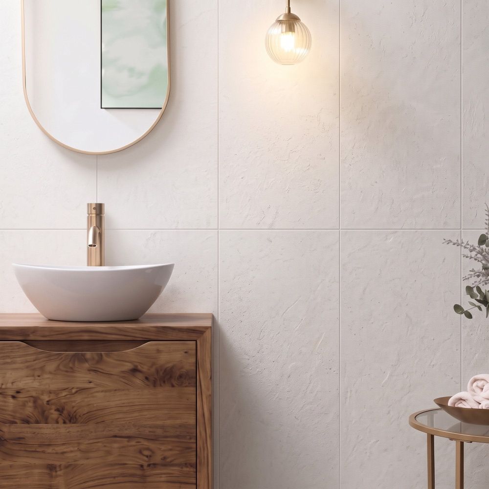 Modern bathroom wall vertically tiled in Kenya Blanco Ceramic Wall Tiles behind a wooden vanity with brass mixer.