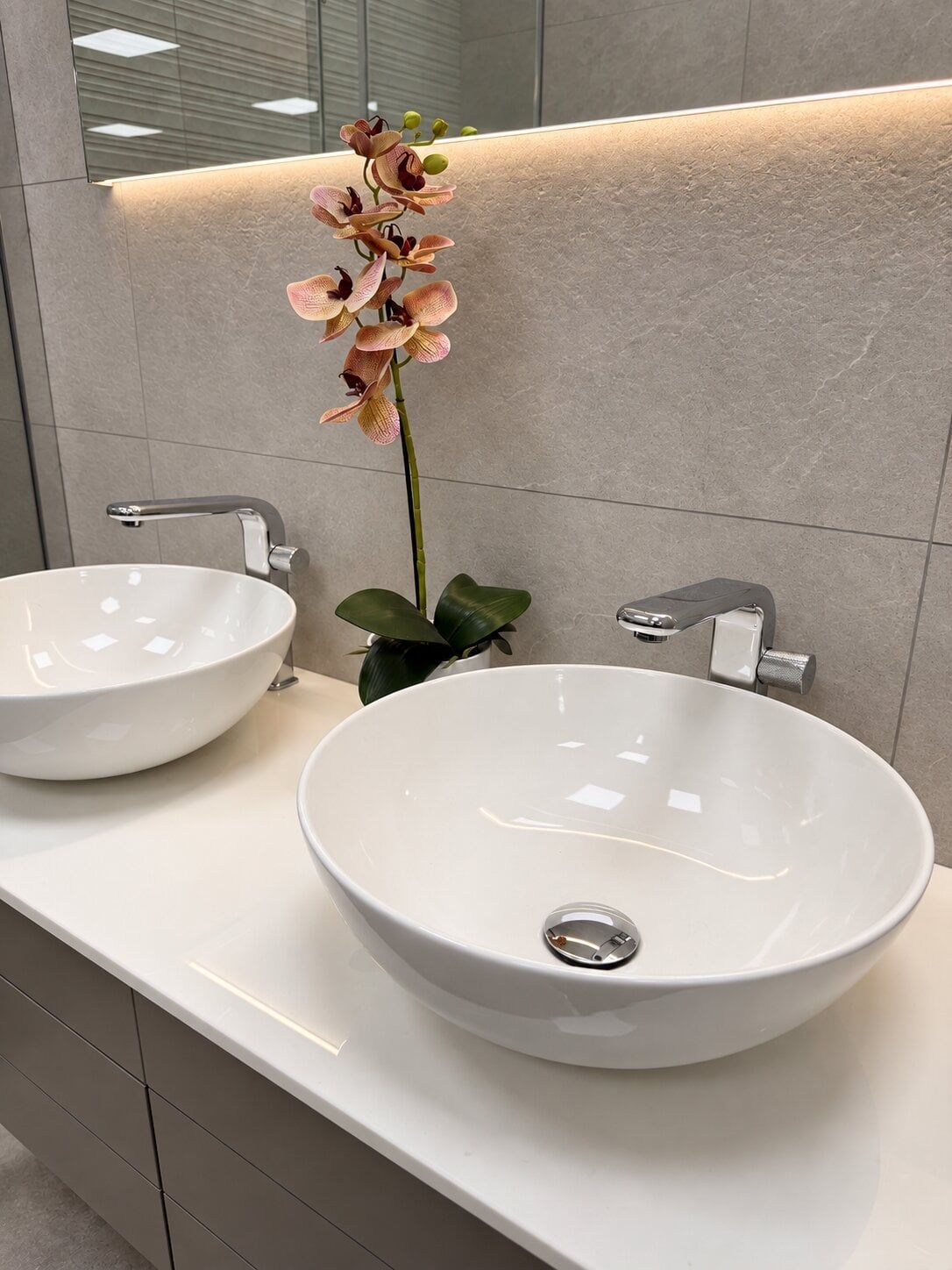Chrome bathroom tap with countertop basin in a modern bathroom display at Easy Bathrooms St Albans.