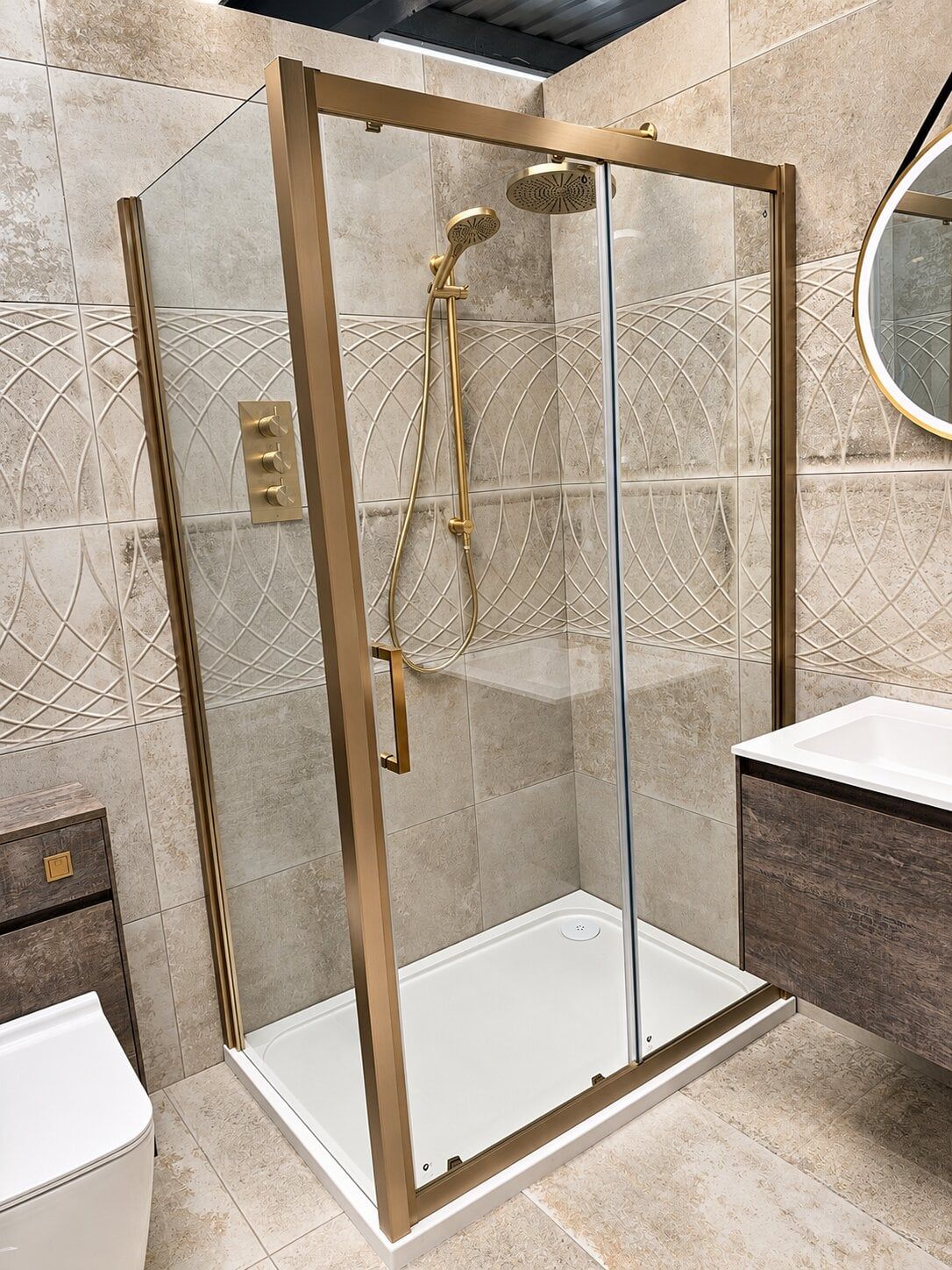 showroom bathroom display featuring fabio shower enclosure in gold