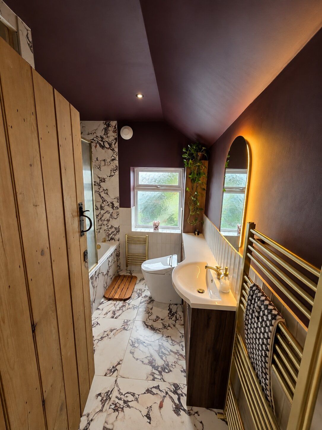 luxurious bathroom space created by Easy Bathrooms & Tiles featuring marble tiles and metallic furniture
