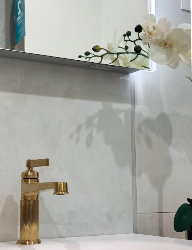 Bathroom showroom display featuring Downton Brushed Gold Basin Tap