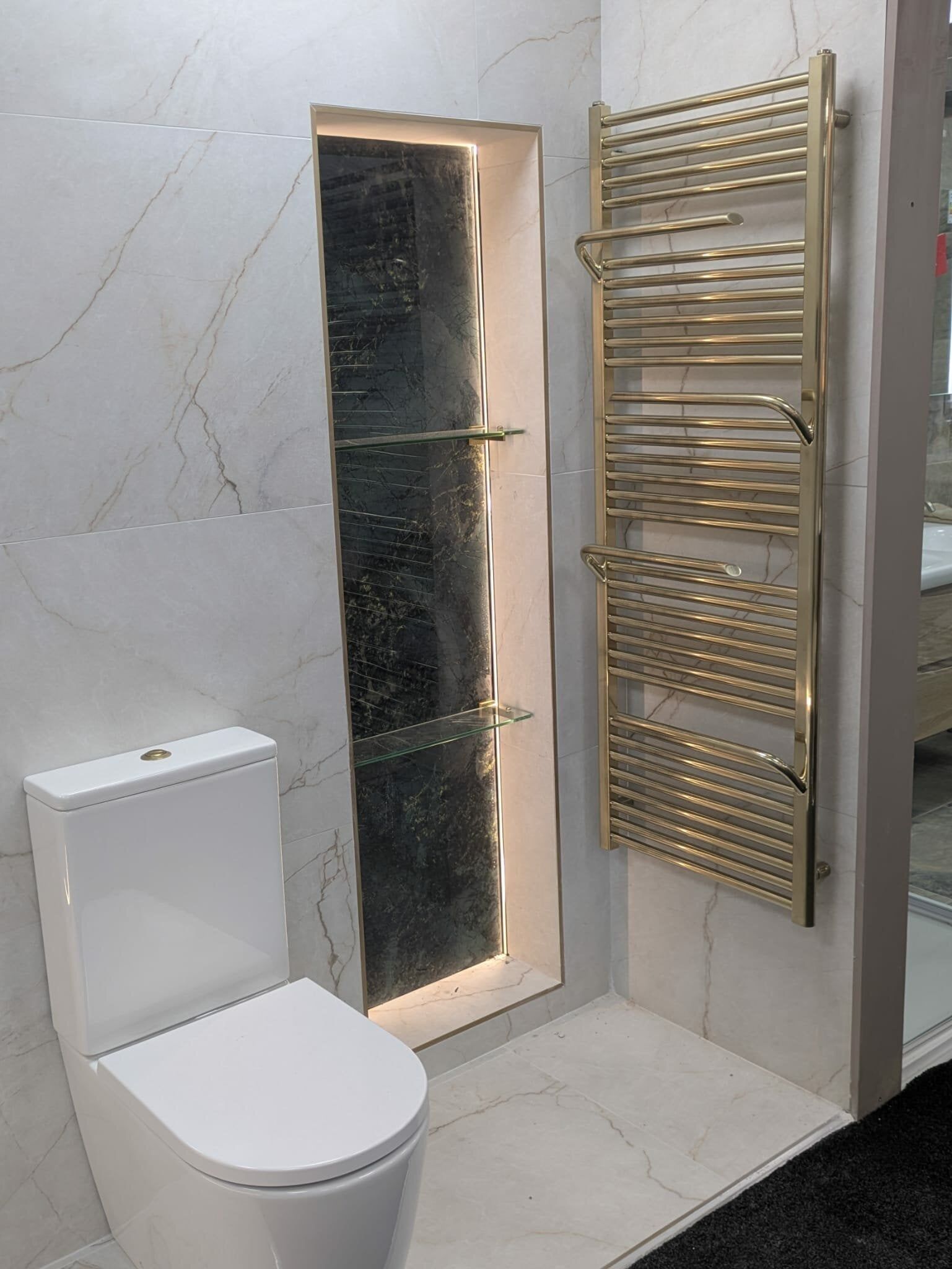 New bathroom display at Easy Bathrooms Bolton featuring wood-effect furniture, white sanitaryware and neutral tiles.