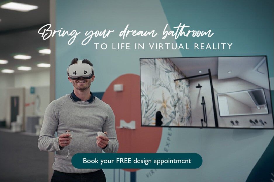 Customer using a virtual reality headset to explore a 3D bathroom design, with a bathroom visualisation displayed on a screen behind him.