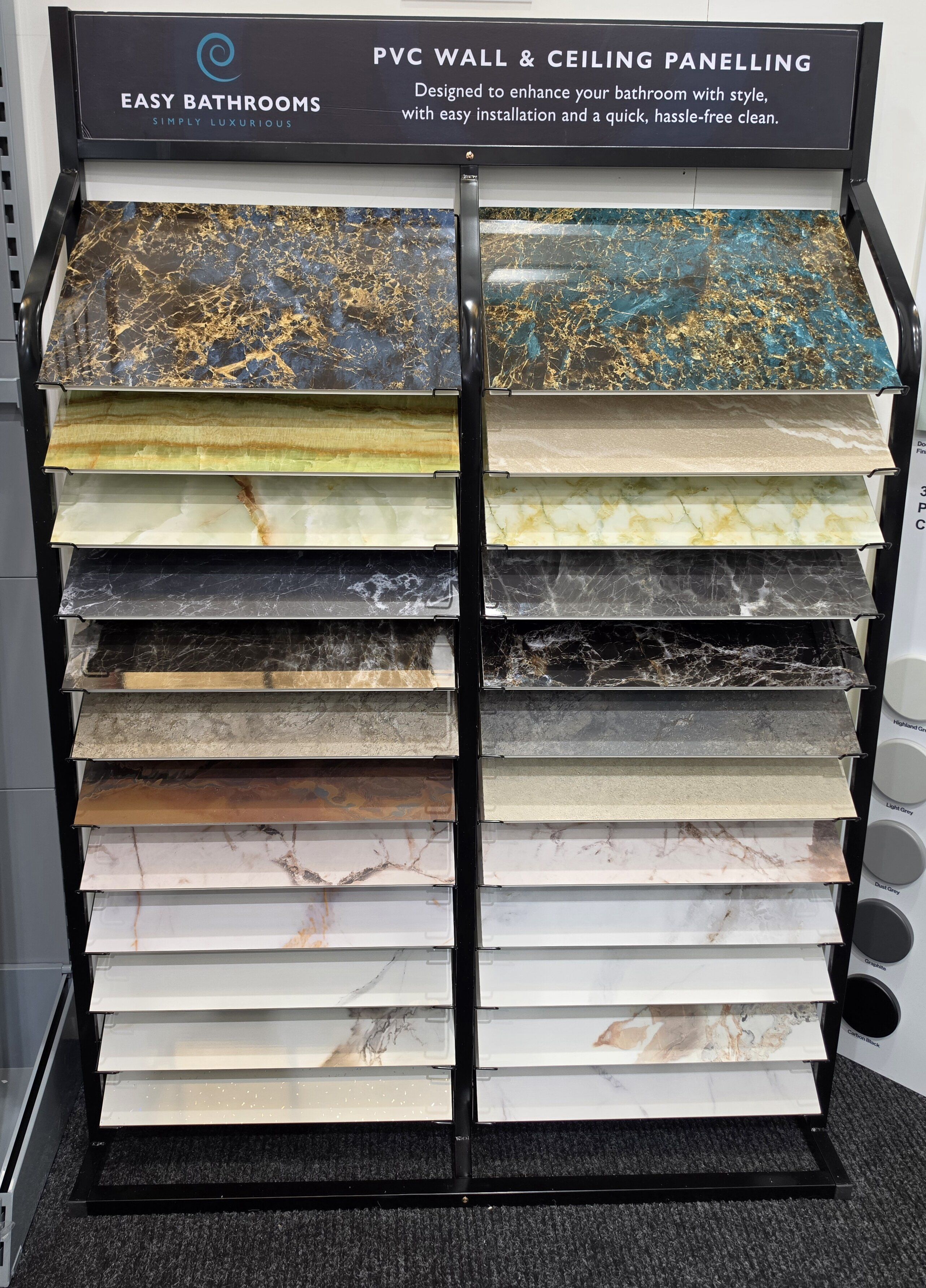 Pristina PVC bathroom wall panel display at Easy Bathrooms Chichester showing a wide range of colours, marble effects and decorative finishes.