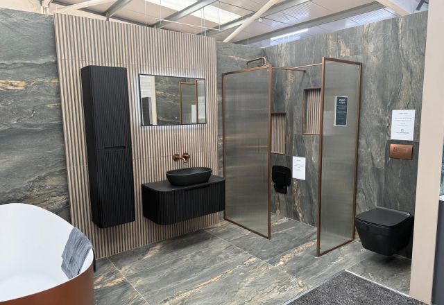 Black bathroom furniture and copper fittings at Lewisham