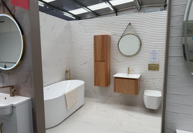 Fluted bath and wood-effect furniture at Easy Bathrooms Lewisham