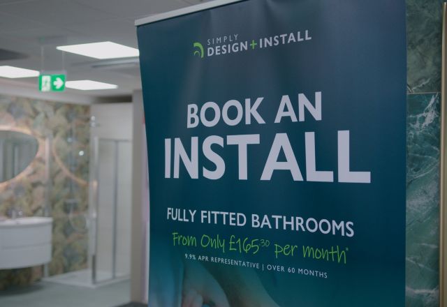 Bathroom showroom display featuring Installation offer banner at Easy Bathrooms Newcastle Airport