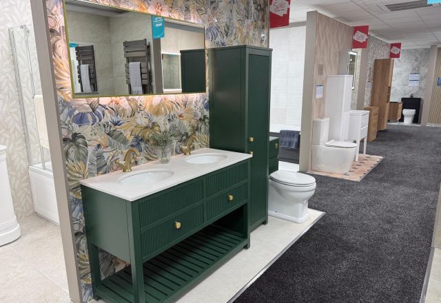Showroom bathroom display featuring emerald green bathroom furniture, botanical tiles and LED mirror