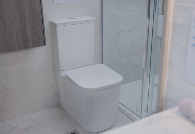 Showroom bathroom furniture display featuring modern white units