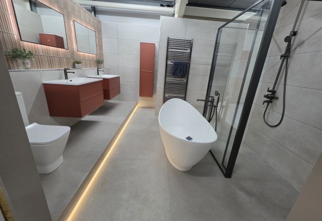 Bathroom display featuring free standing bath, double vanity vasins and modern shower tray
