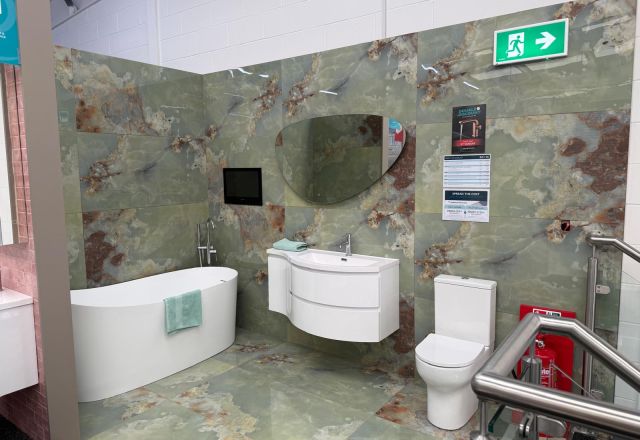 Green marble-effect bathroom display at Easy Bathrooms Lewisham