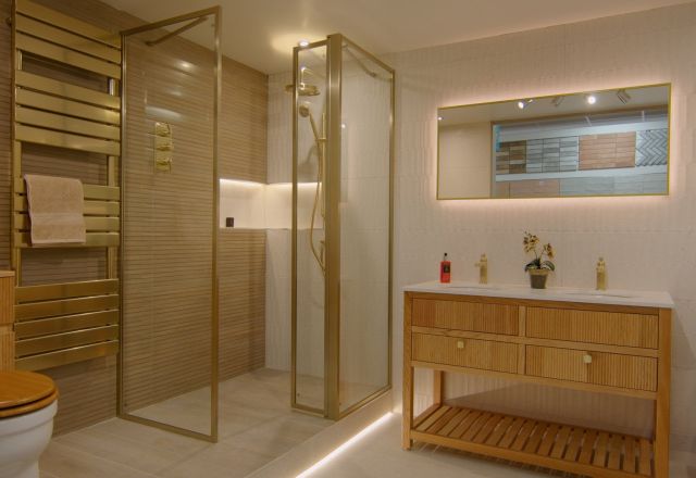 Bathroom furniture display at Easy Bathrooms Newcastle Airport featuring glass shower screen, tiles and wood effect vanity unit