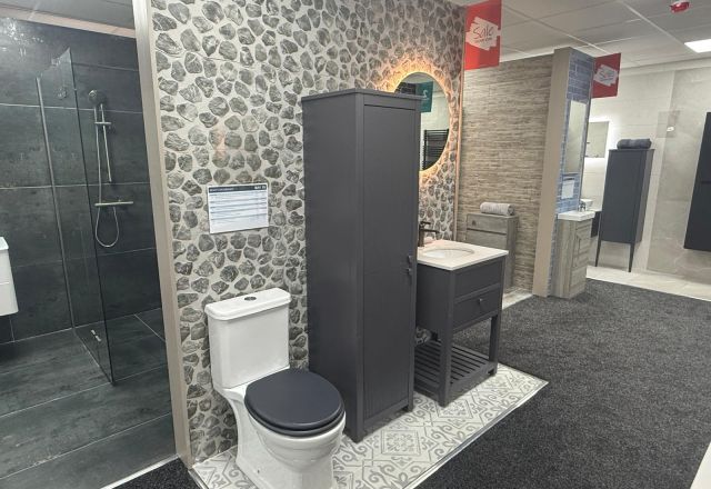 Bathroom furniture display featuring stone effect tiles and anthracite grey bathroom furniture