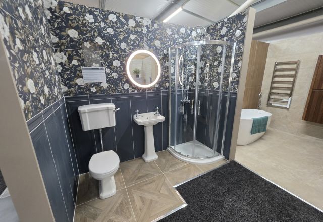 Showroom bathroom display featuring floral tiles and traditional bathroom furniture