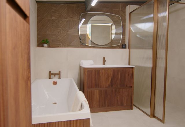 Bathroom showroom featuring modern wood furniture and warm lighting