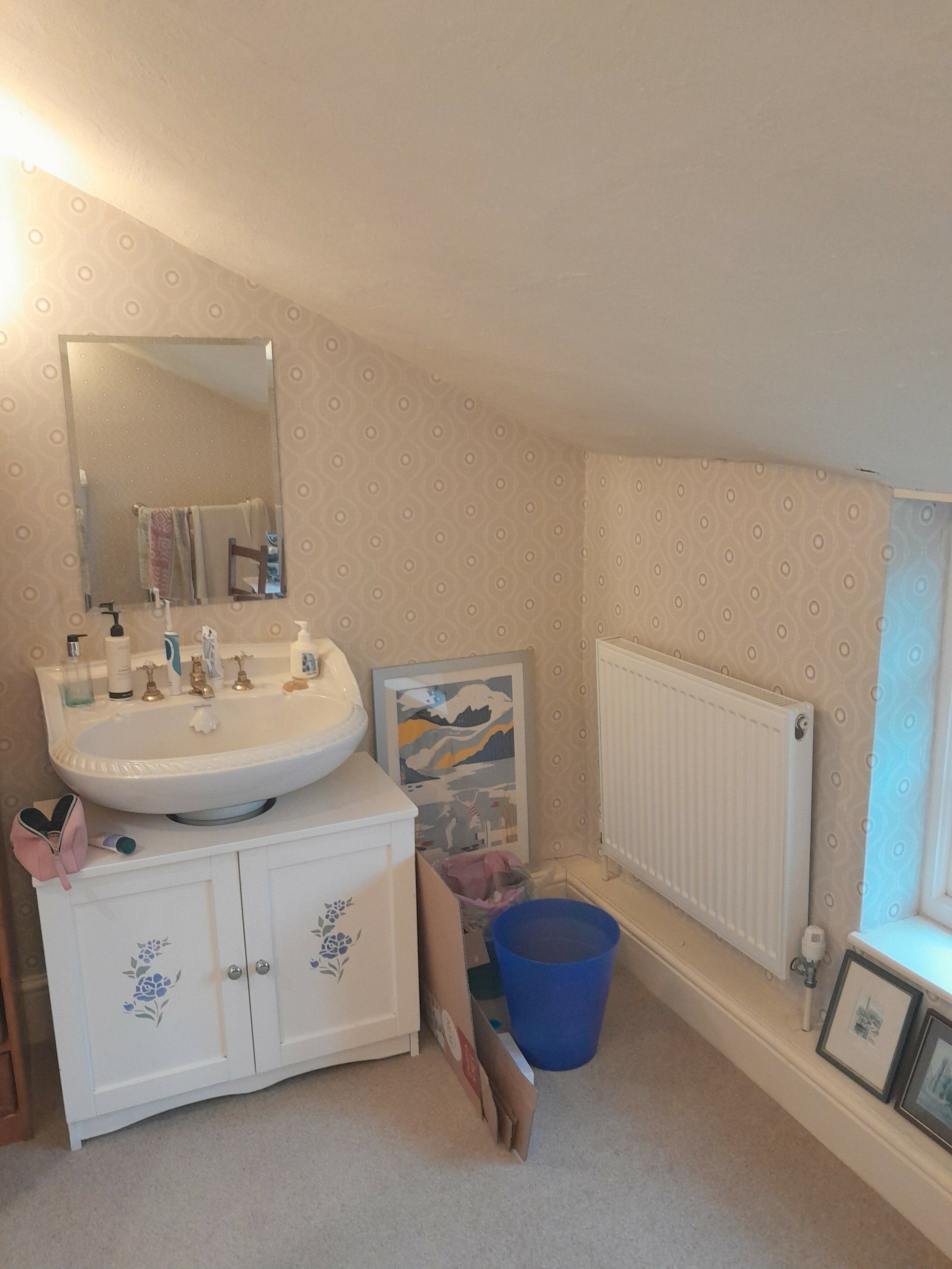1. Customer bathroom before renovation, showing the original basin unit and tiled floor.