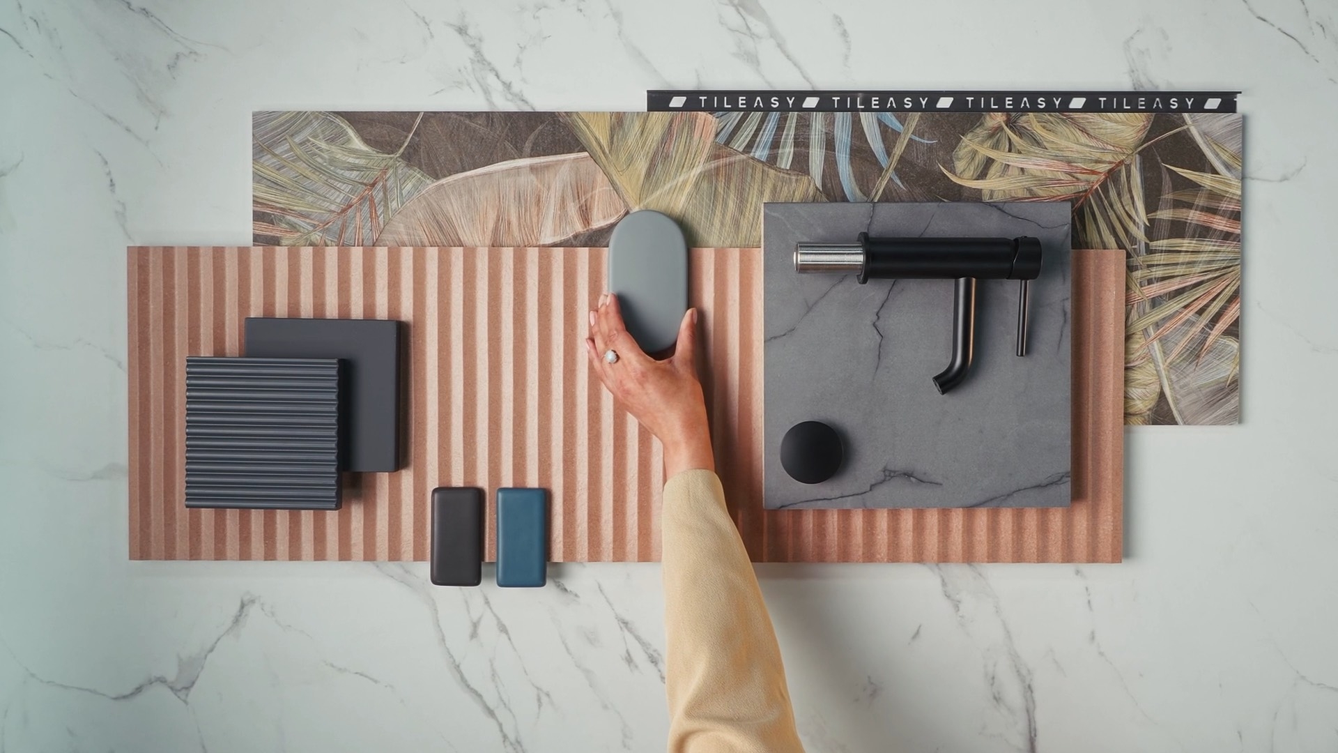 Bathroom material flatlay with brassware and samples