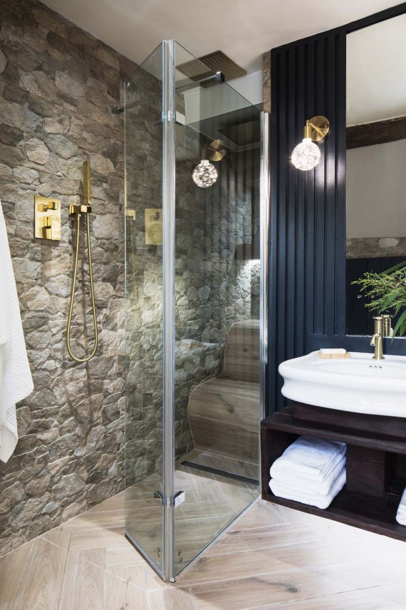 Topeka Noce stone tiles and a Royle walk-in screen meet a Laine console basin and herringbone Wendu flooring.