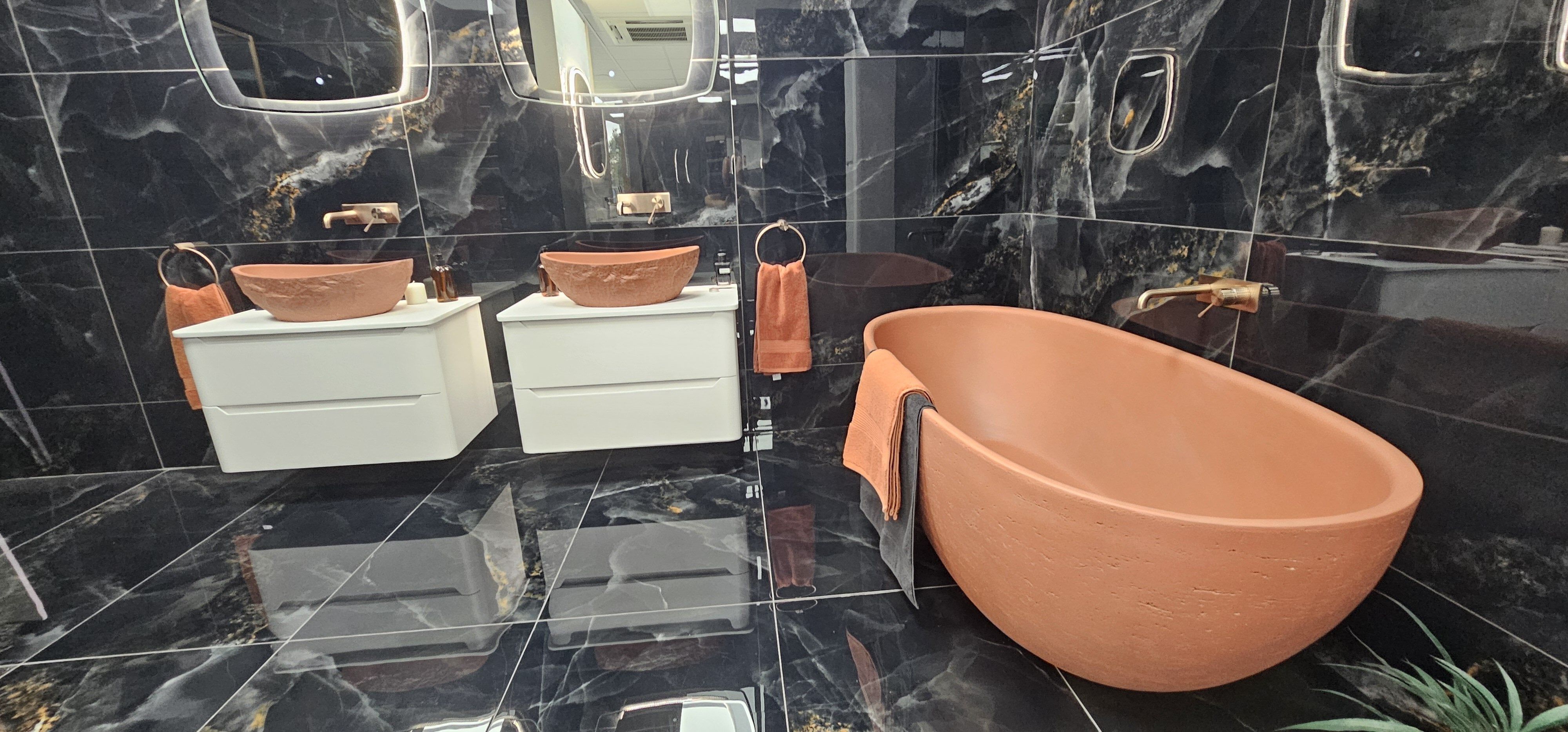 Terracotta free standing bath with black marble tiles featured in Easy Bathrooms Crawley