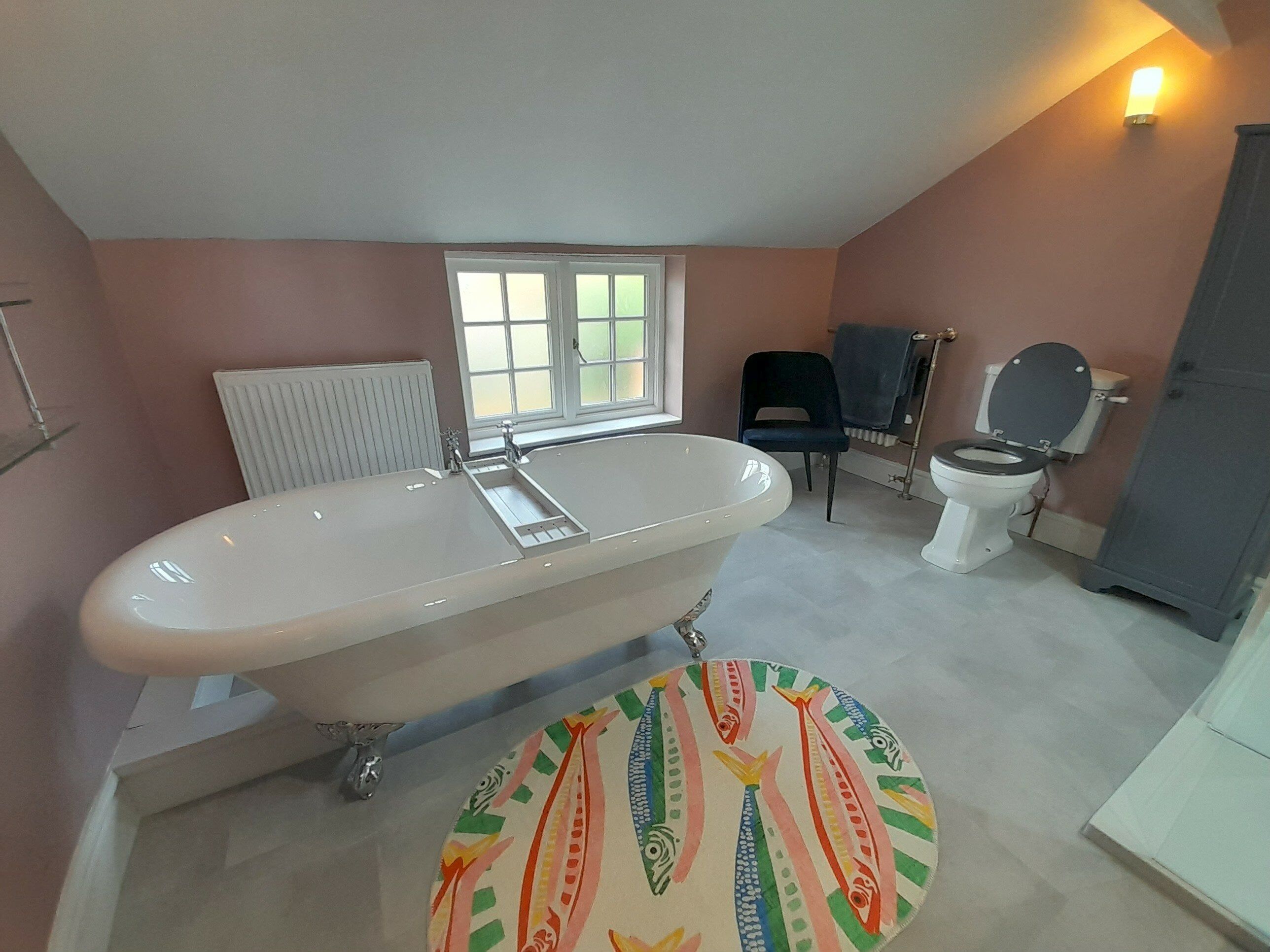 Freestanding bath and traditional vanity area in the completed Grantham bathroom.