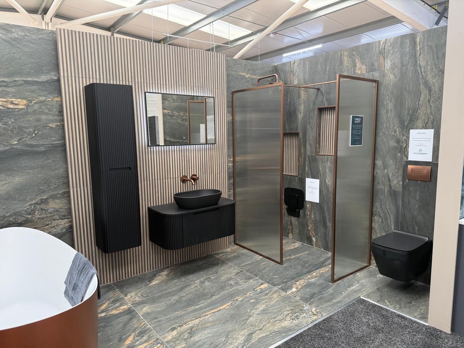 Black bathroom furniture and copper fittings at Lewisham