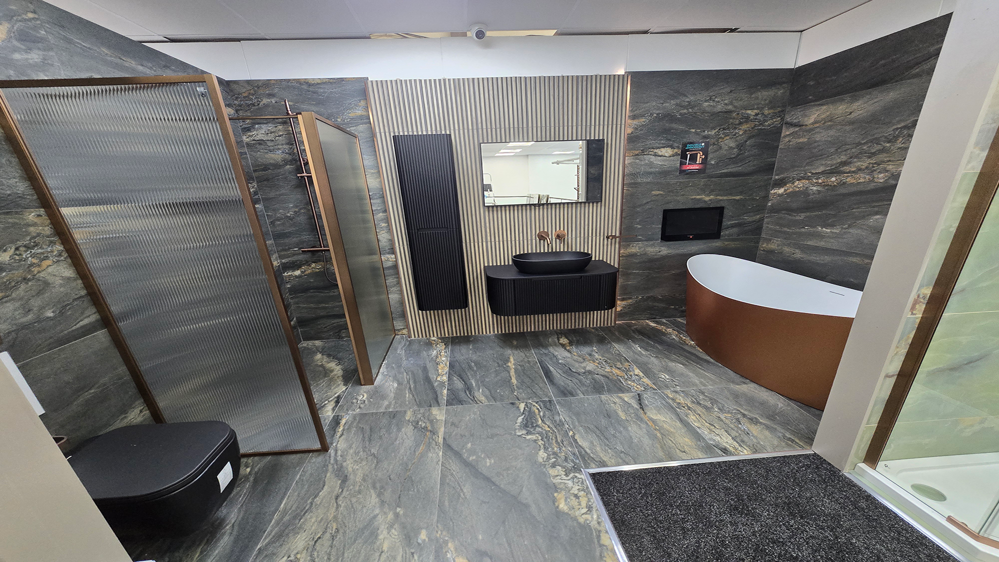 Easy Bathrooms & Tiles Showroom Newbury display stand featuring a modern bathroom suite with an onyx marble tile floor to ceiling