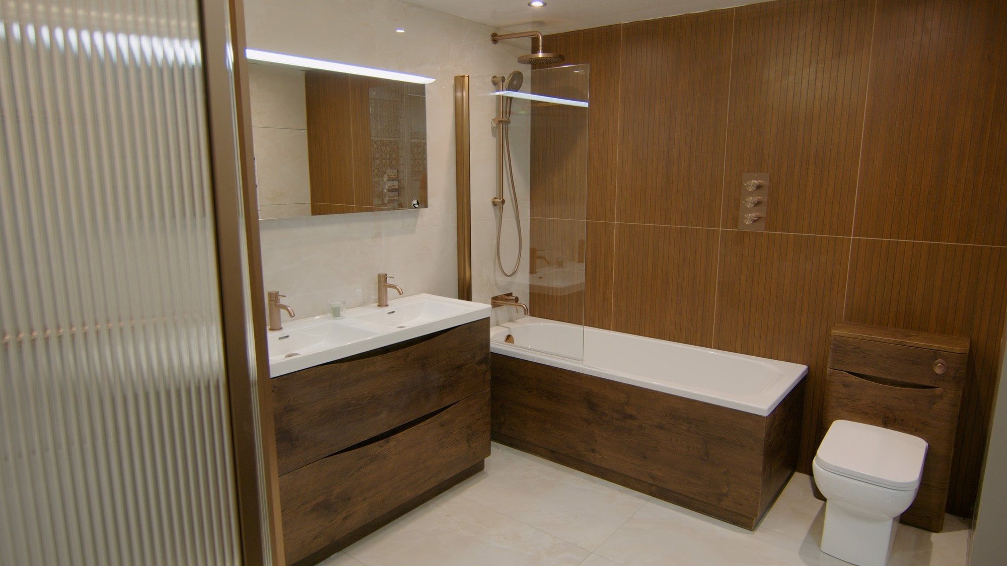 Bathroom furniture showroom display featuring fluted glass shower panel and modern bathroom furniture