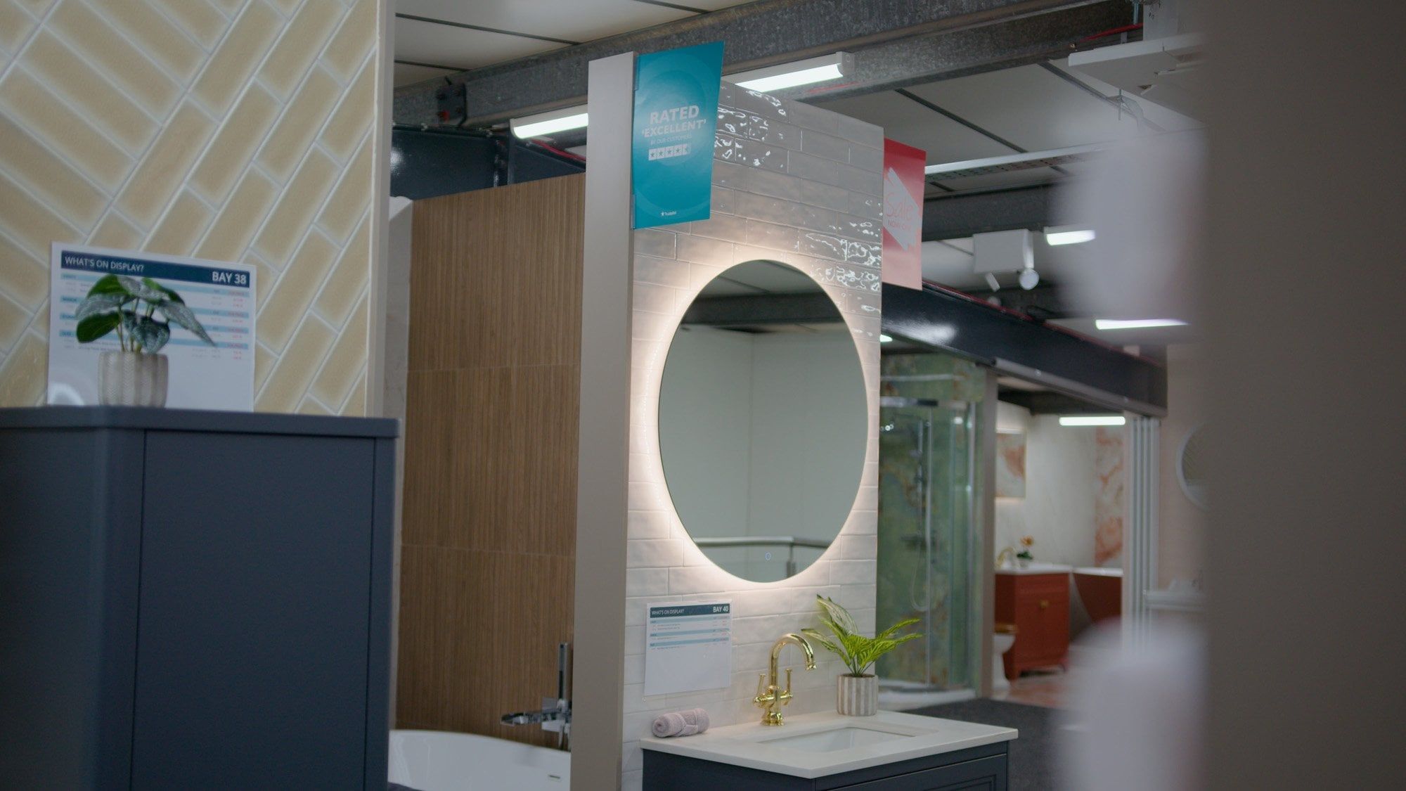 Bathroom furniture display featuring warm LED lit mirror and yellow tiles