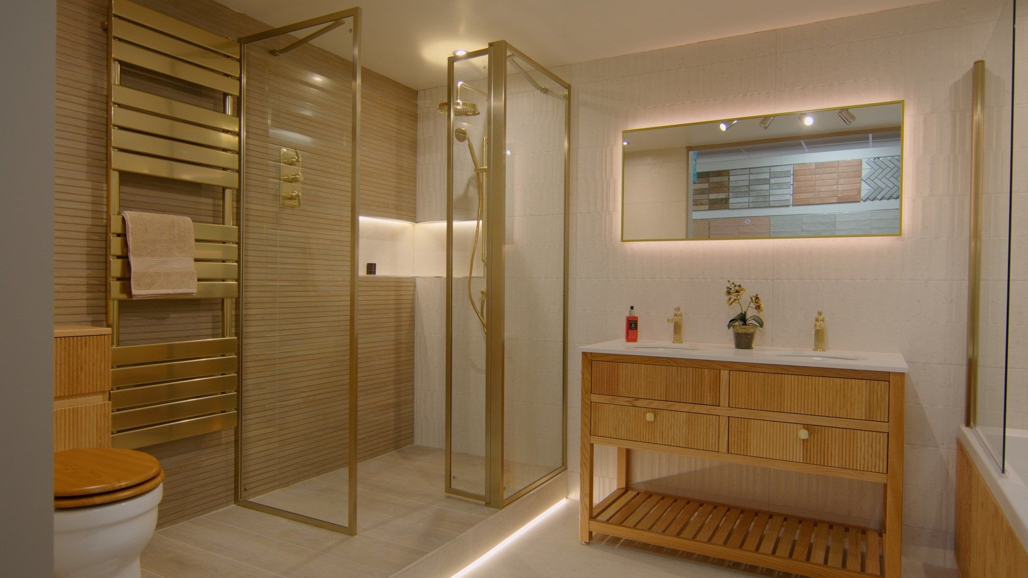 Bathroom furniture display at Easy Bathrooms Newcastle Airport featuring glass shower screen, tiles and wood effect vanity unit