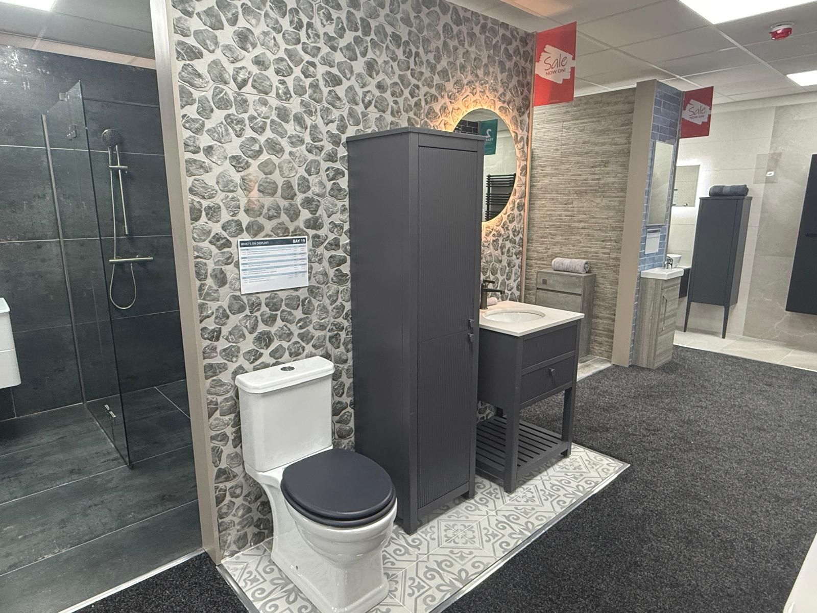 Bathroom furniture display featuring stone effect tiles and anthracite grey bathroom furniture