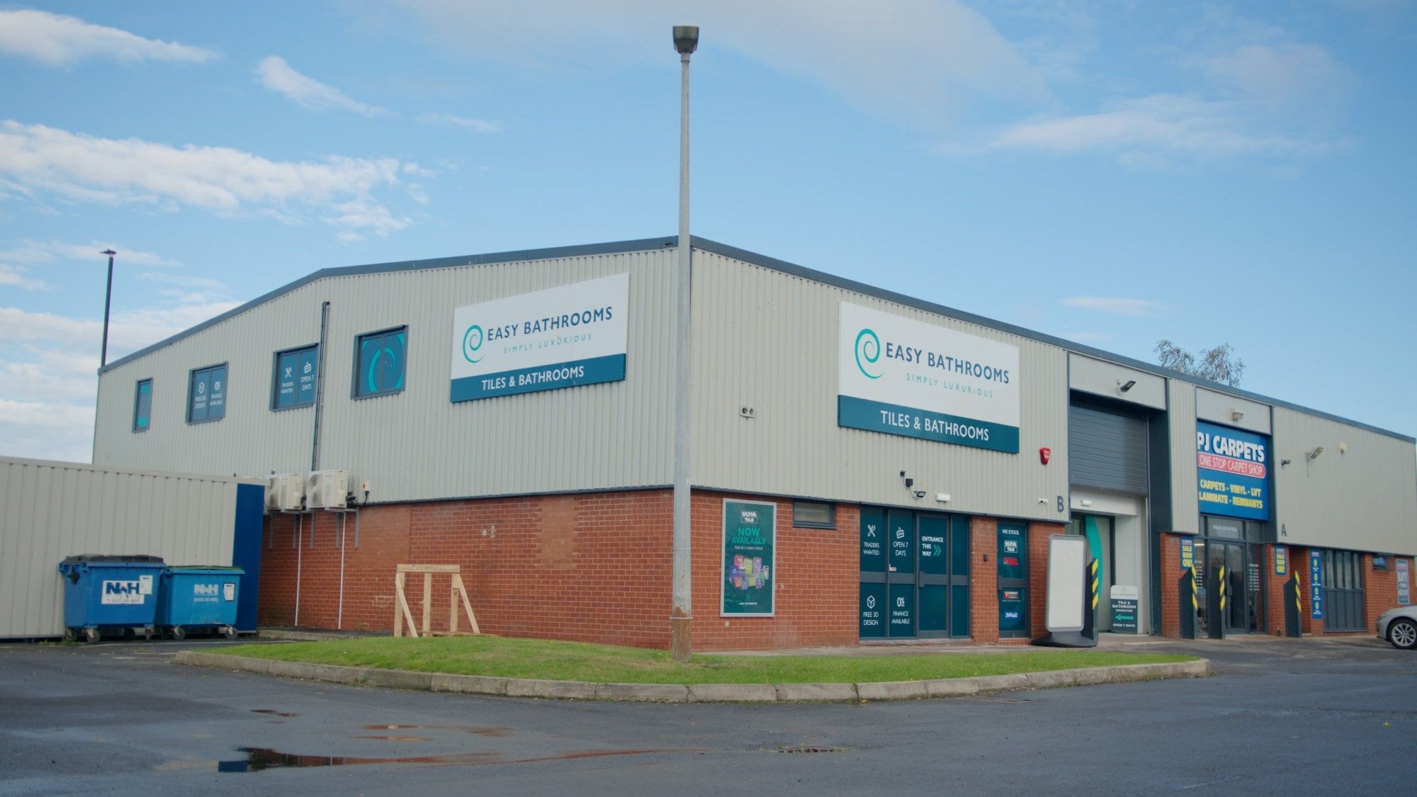 Easy Bathrooms & Tiles Newcastle Airport building from the outside showing parking
