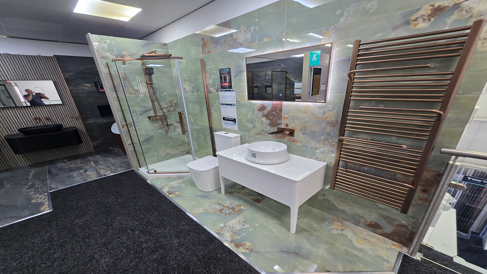 Easy Bathrooms & Tiles Showroom Newbury display stand featuring a modern bathroom suite with green marble tiles