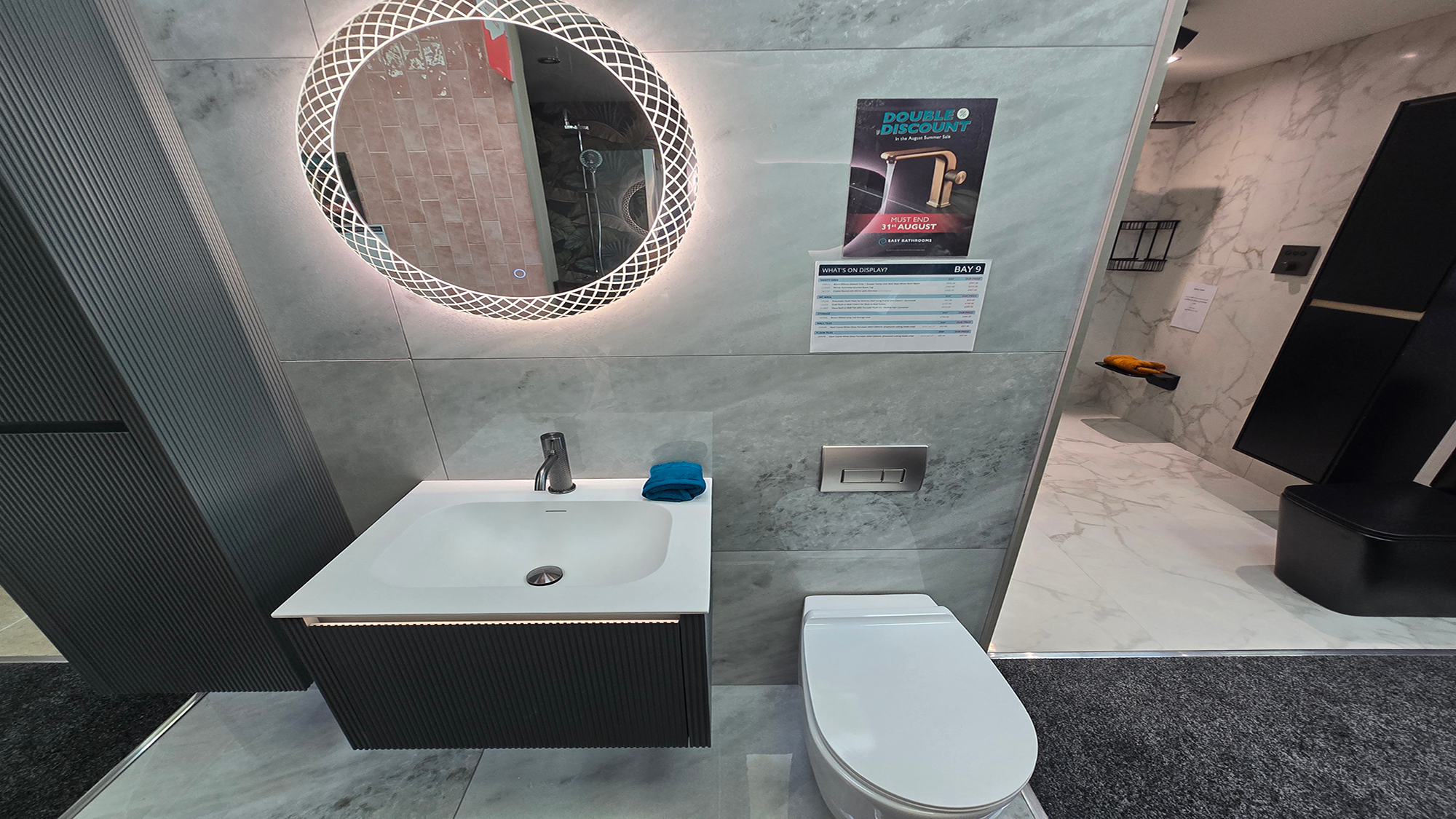 Easy Bathrooms & Tiles Showroom Newbury display stand featuring a modern bathroom suite with an LED mirror