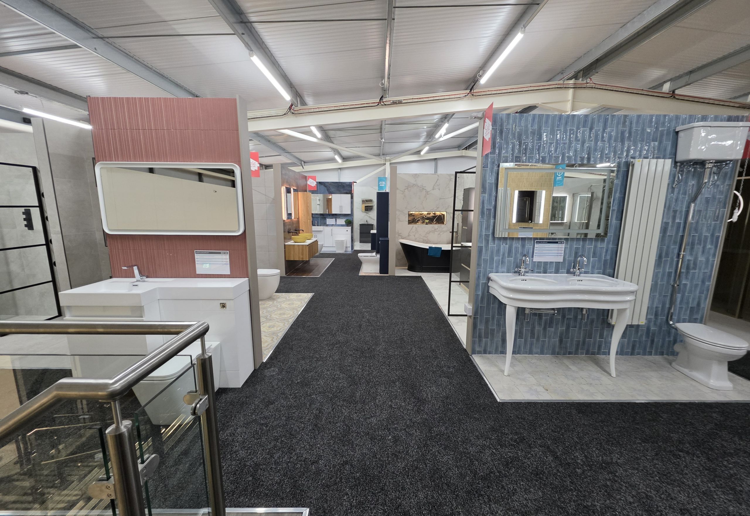 bathroom display units on the second floor of Cirencester Easy Bathrooms, featuring modern tiles and bathroom furniture